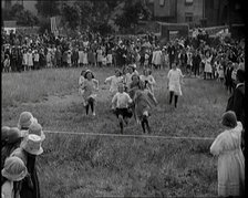 Young Girls Finishing a Running Race in a Field, 1920. Creator: British Pathe Ltd.