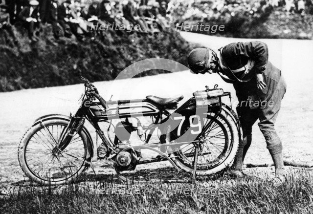 Norman Black repairing a punture on his Norton bike, 1920. Artist: Unknown