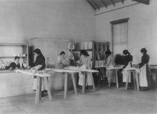 Classroom scenes at Carlisle, Pa., Indian School. Ironing; women students, 1901. Creator: Frances Benjamin Johnston.