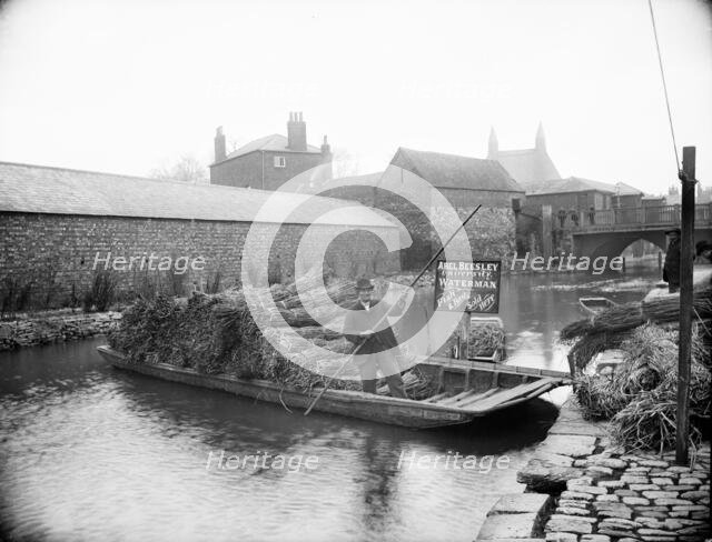 Waterman Abel Beesley on his punt full of bundles of rushes, Fisher Row, Oxford, Oxfordshire, 1901. Creator: Henry Taunt.