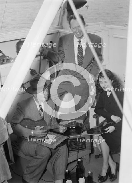 Portrait of Cliff Edwards, Betty Brewer, and Frank...Ukelele Lady (yacht), Hudson River, N.Y., 1947. Creator: William Paul Gottlieb.