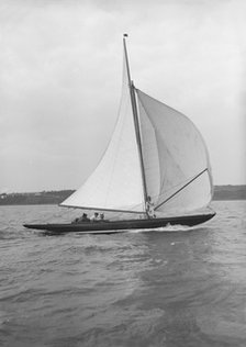 The 7 Metre 'Anitra' (K4) sailing with spinnaker, 1913. Creator: Kirk & Sons of Cowes.