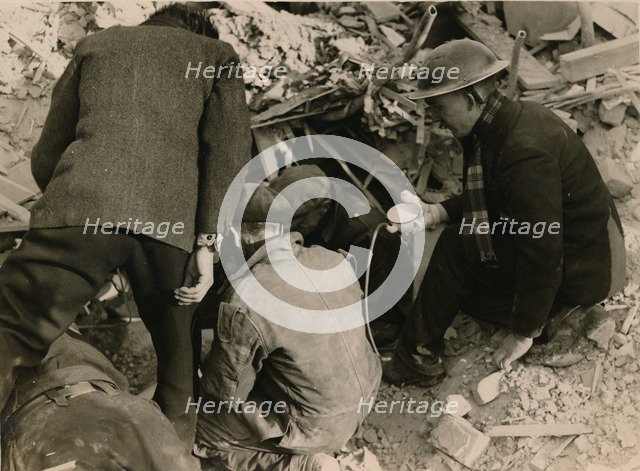 Family buried in a Morrison shelter after a raid, London, 1944. Artist: Unknown