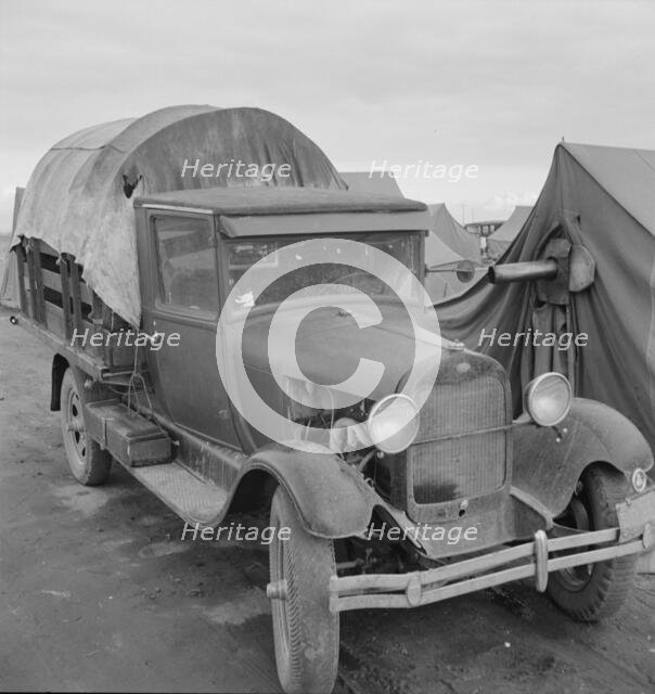 Truck, baby parked on front seat, FSA camp, Merrill, Klamath County, Oregon, 1939. Creator: Dorothea Lange.