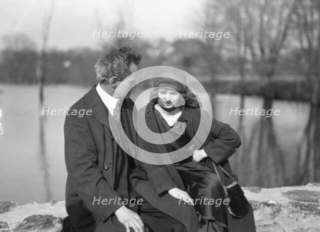 Arnold Genthe seated outdoors with a woman friend, between 1896 and 1942. Creator: Arnold Genthe.