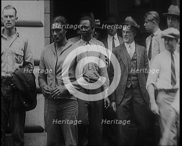 Alcohol Smugglers Coming Out of Court, 1929. Creator: British Pathe Ltd.