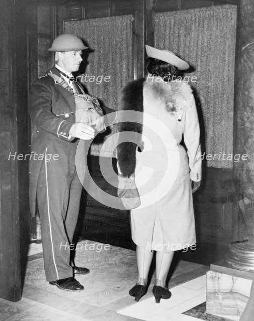 Linkman at the Trocadero wearing a tin hat, Westminster, London, October 1940. Artist: Unknown