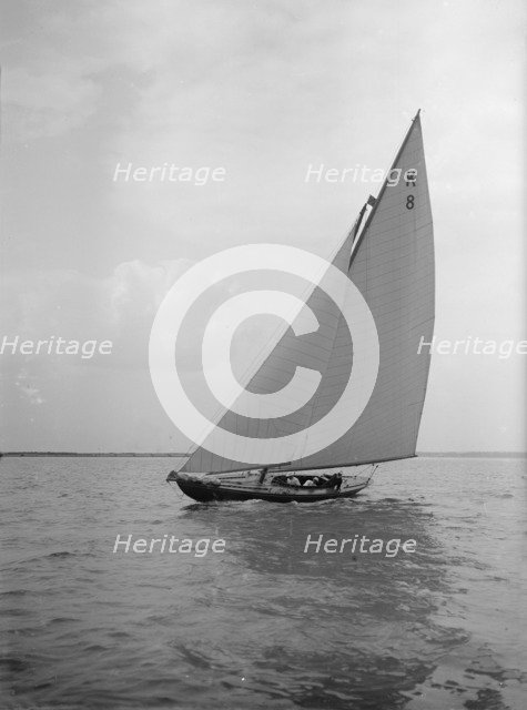 The 7 Metre yacht 'Pinaster' (K8) sailing with spinnaker, 1912. Creator: Kirk & Sons of Cowes.