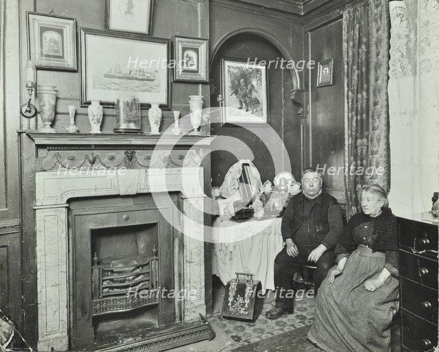 Elderly couple in Victorian interior, Albury Street, Deptford, London, 1911. Artist: Unknown.