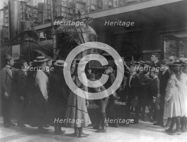 Viewing locomotive at Smithsonian, Washington, D.C., (1899?). Creator: Frances Benjamin Johnston.
