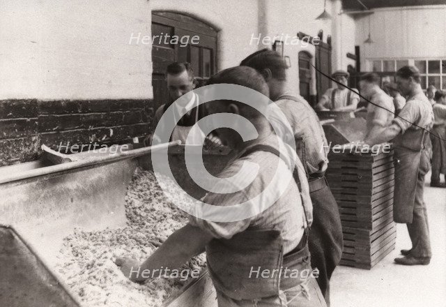 Men hand sugaring fruit pastilles, Rowntree factory, York, Yorkshire, 1920. Artist: Unknown