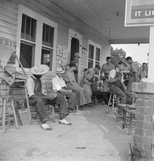 Rural filling station becomes community center...for loafing, near Chapel Hill, North Carolina, 1939 Creator: Dorothea Lange.
