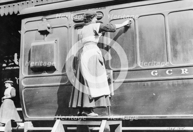 A woman cleaning railway carriages at Marylebone station, April 1915. Artist: Unknown