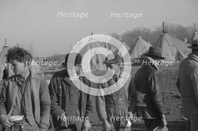 Possibly: Refugees lined up at meal time in the camp for white flood...Forest City, Arkansas, 1937. Creator: Walker Evans.