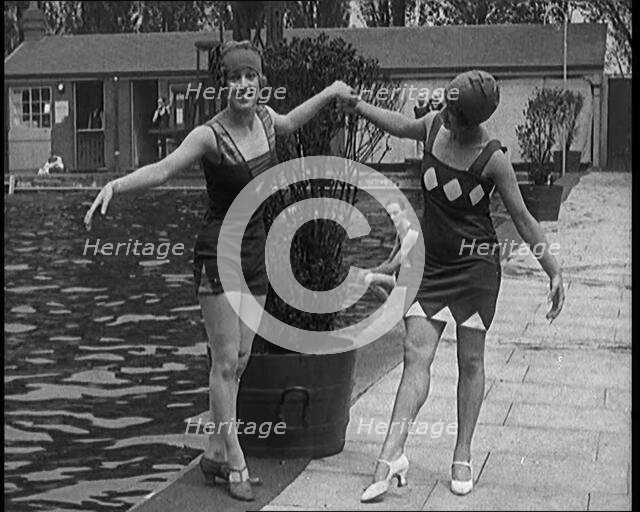 Two Young Female Civilians Wearing Short Swimsuits and Heeled Shoes Posing for the Camera..., 1920. Creator: British Pathe Ltd.