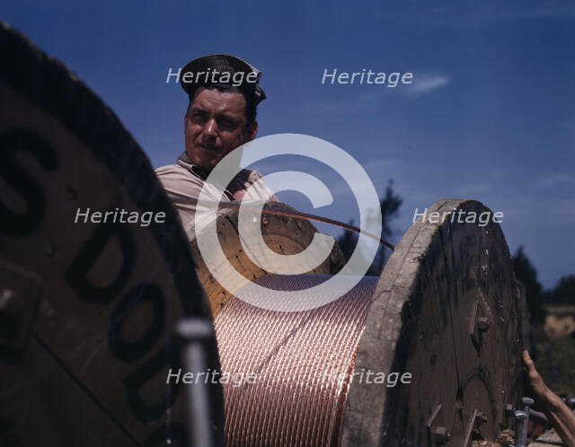 This husky member of a construction crew building a new 33,000-volt..., Fort Knox, Ky., 1942. Creator: Alfred T Palmer.