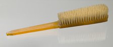 Bakelite clothes brush from dresser set owned by Lena Horne, mid 20th Century. Creator: Agalin.