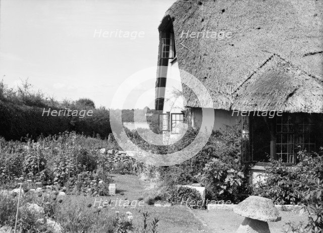 Thatched cottage and garden, c1935. Creator: Kirk & Sons of Cowes.