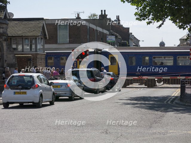 Train passing through level crossing in Lincoln 2014 Artist: Unknown.