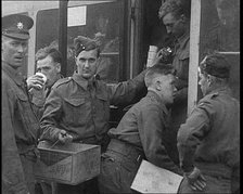 British Soldiers Receiving Food and Drinks on Trains Taking Them To Camp, 1940. Creator: British Pathe Ltd.