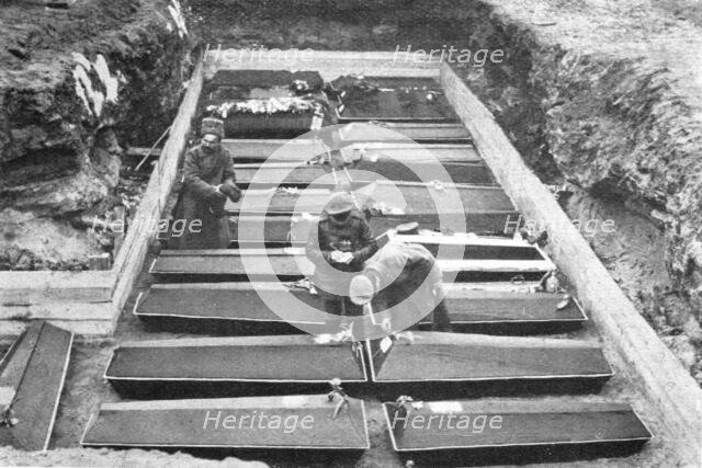 'Les Funerailles des Morts de la Revolution; Les cercueils ranges dans la fosse, au Champ..., 1917. Creator: Unknown.