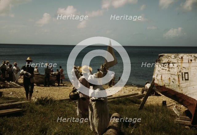 Housewives at the seashore waiting for the fishing boats to come in Frederiksted, V.I., 1941. Creator: Jack Delano.