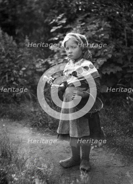 Little girl with basket and flowers in hands, 1898-1900.  Creator: Johan Severin Nilson.