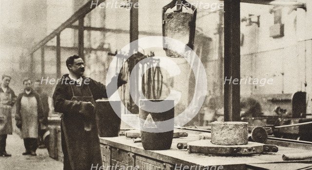 Making money; pots of liquid metal being handled in the melting room, 20th century. Artist: Unknown