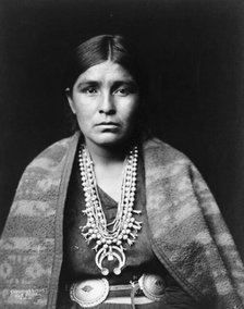 Head-and-shoulders portrait of Navajo woman, facing front, c1904. Creator: Edward Sheriff Curtis.