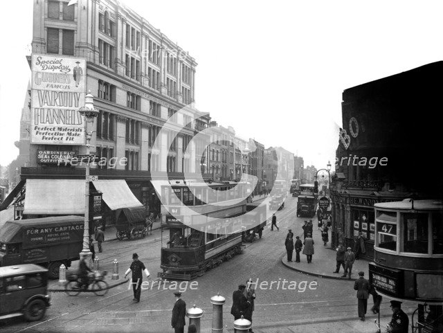 A policeman stands on point duty at the corner of Commercial Road, London. Artist: Unknown