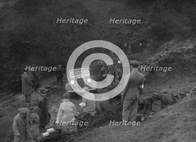 Ford V8 drop head coupe of GM Denton competing in the MCC Sporting Trial, 1935. Artist: Bill Brunell.