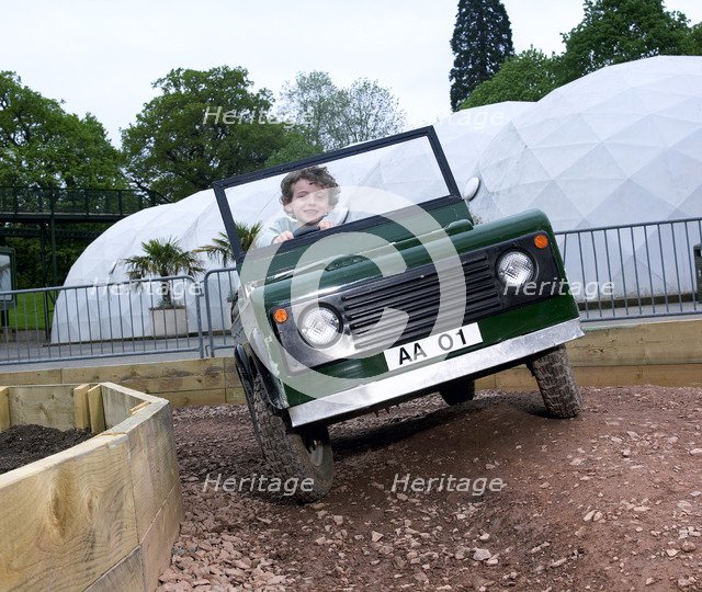 Child driving a toy Land Rover. Artist: Unknown.