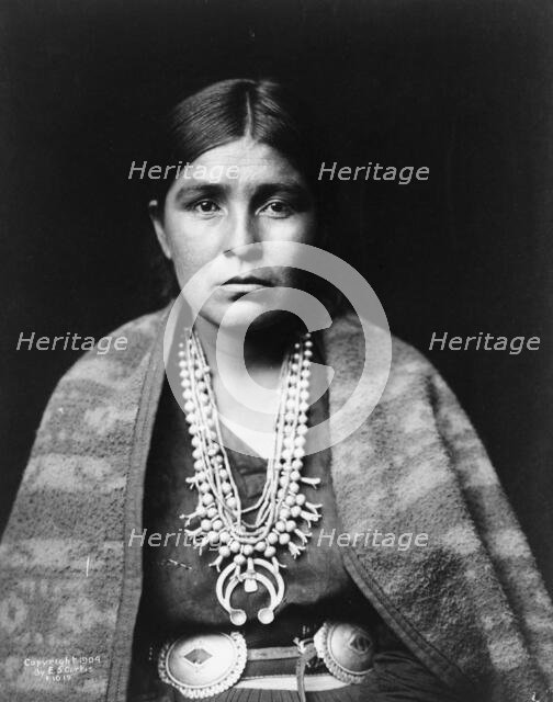 Head-and-shoulders portrait of Navajo woman, facing front, c1904. Creator: Edward Sheriff Curtis.