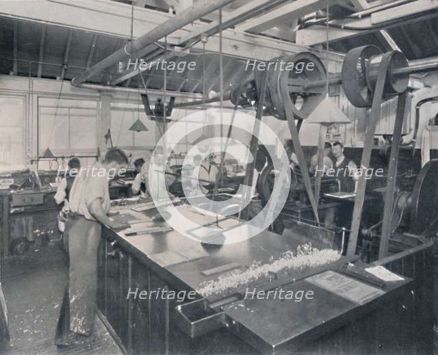 'Final Operations in the Foundry. Trimming the Plates and Finishing', 1917. Artist: Unknown.