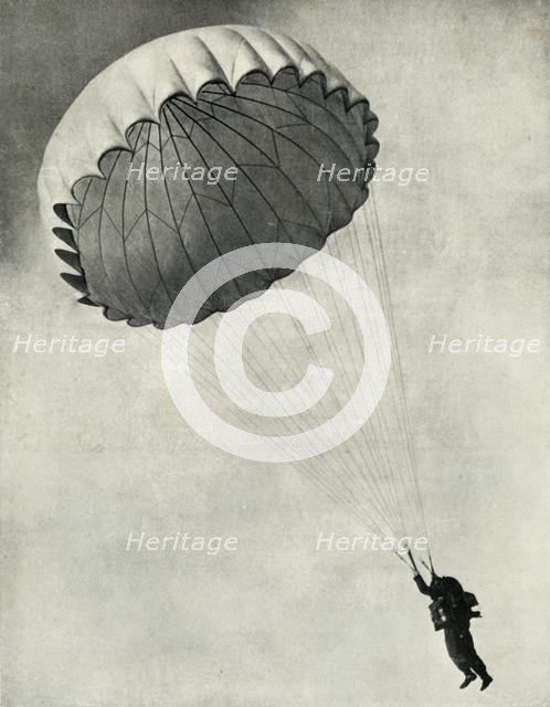 Airman using a parachute during the Second World War, 1941. Creator: Charles Brown.