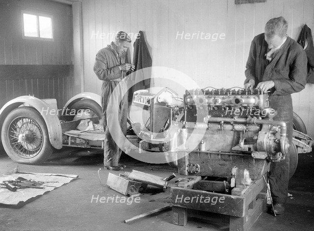 Mechanics working on Raymond Mays' 4500 cc Invicta car. Artist: Bill Brunell.