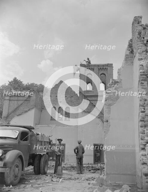 Loading debris from wrecked buildings on Independence Avenue, Washington, D.C, 1942. Creator: Gordon Parks.