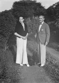 Leonard, Mr. and Mrs., standing outdoors, between 1926 and 1938. Creator: Arnold Genthe.