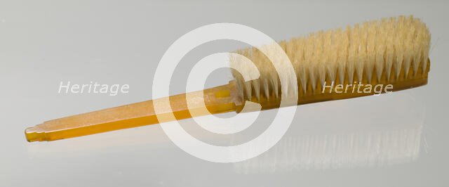 Bakelite clothes brush from dresser set owned by Lena Horne, mid 20th Century. Creator: Agalin.