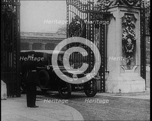 A Uniformed Male and a Male British Police Officer Standing Outside the Gates of Buckingham..., 1924 Creator: British Pathe Ltd.