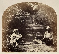 Goruckpoor, India: two men sqatting on a tree-lined path, c1860s. Creator: Unknown.