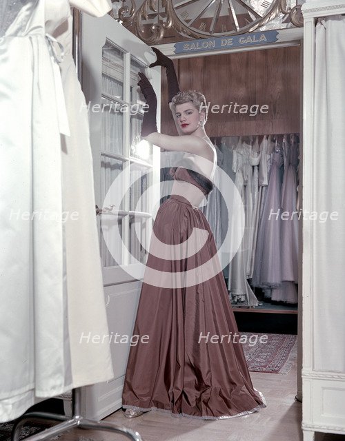 Female model shows an evening dress, Stockholm, 1950s. Artist: Göran Algård