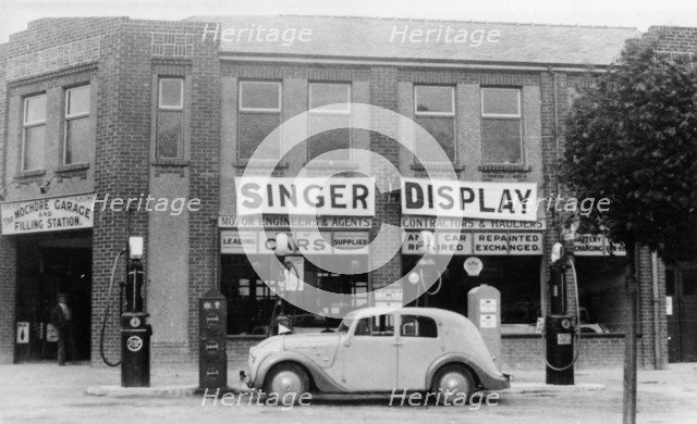 A Singer 11hp Airstream saloon car outside a Welsh garage, Wales, 1935. Artist: Unknown