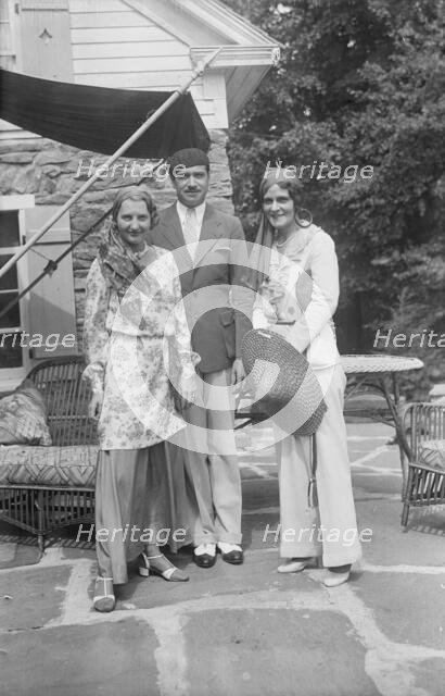 Pierre de Beaumont and two unidentified women, standing outdoors, between 1932 and 1942. Creator: Arnold Genthe.