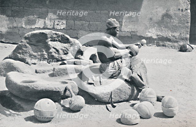 A Yoruba man engraving clay bowls and water jars, Lagos hinterland, Southern Nigeria, 1912. Artist: AW Gelston.