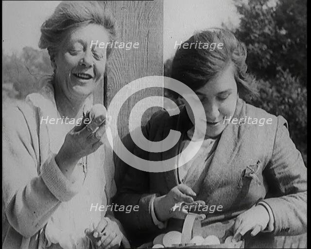 Stage Star Syndey Fairbrother Collecting Hen Eggs on Her Farm, 1920s. Creator: British Pathe Ltd.
