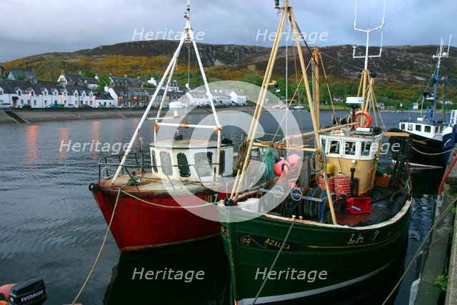 Fishing boats in Ullapool harbour at night, Highland, Scotland.