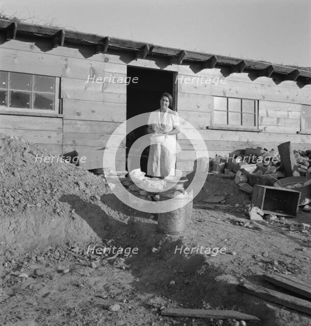 Mrs. Dougherty in doorway of basement house, Warm Springs, Malheur County, Oregon, 1939. Creator: Dorothea Lange.