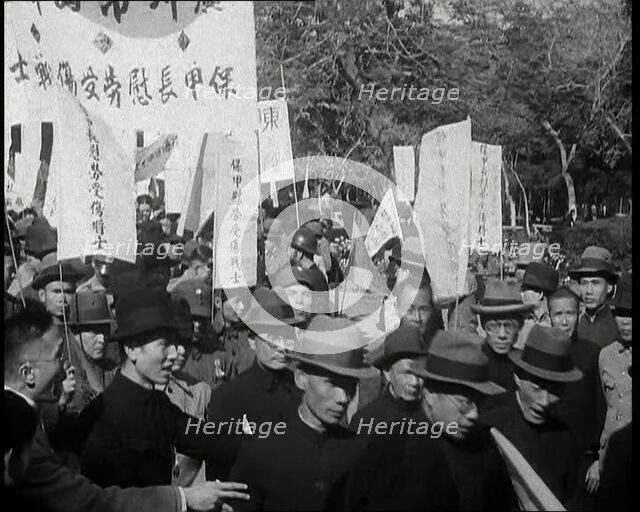 A Chinese Anti-War Protest With Male Attendees Both Military and Civilian Present Some..., 1938. Creator: British Pathe Ltd.