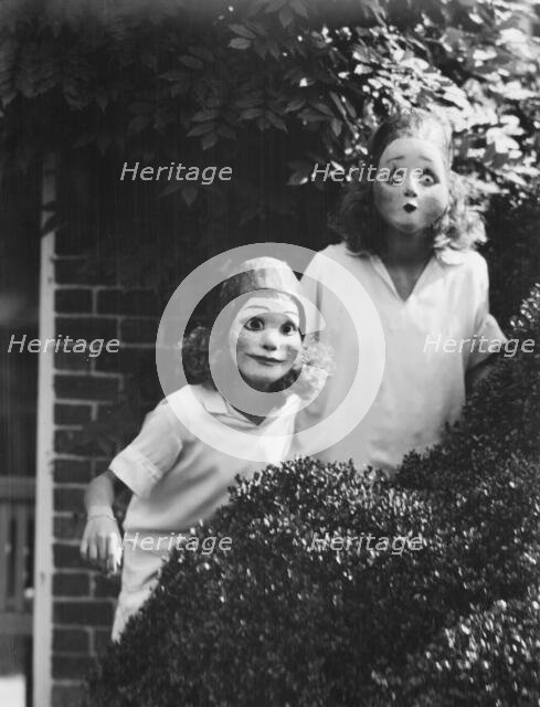 People wearing masks made by W.T. Benda, 1925 Sept. 20. Creator: Arnold Genthe.
